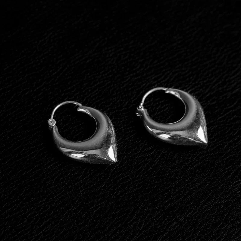 Chevron-shaped 925 sterling silver hoop earrings in medium size, showing gauge thickness and structural profile on a model.