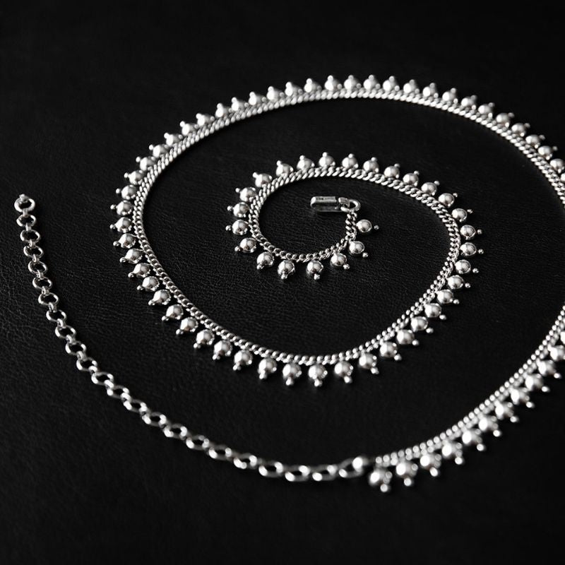 Beaded 925 sterling silver waist chain with evenly spaced round links and a small clasp, laid out in a curved line.